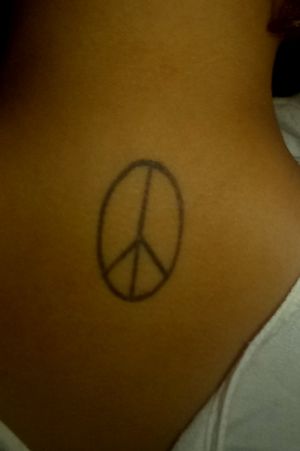 My Tiffany's tattoo. On my 20th birthday I got this one. My friend Tiffany paid for it and her another friend and I got peace love and happiness inspired matching tats. If we all get together the tattoos are on our way of saying that peace of mind mind and it's on my neck. Tiffany's tattoo is love and it's a black heart on her left color bond. And the other friend has the tat of a smiley face on her belly?