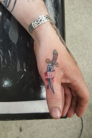 Thumb dagger tattoo