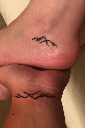The mountains are calling and I must go 💙 mountain tattoos my love and I got during her birthday trip to the Smoky Mountains #mountain #mountaintattoo #smokymountains #wristtattoo #foottattoo #ankletattoo 