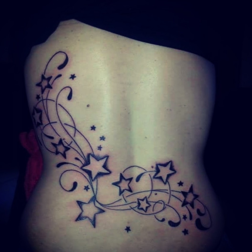 stars and swirls tattoos on hip