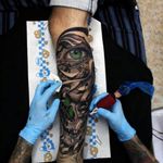 Eye and clock and skull tattoo leg sleeve 