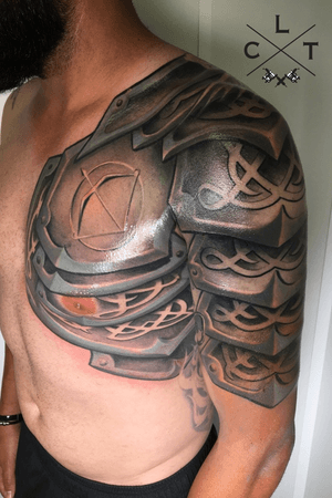 Black and grey tattoo. Armor tattoo. Shoulder tattoo