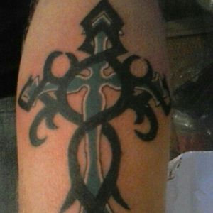 Tribal cross on my husband's arm about five years ago.