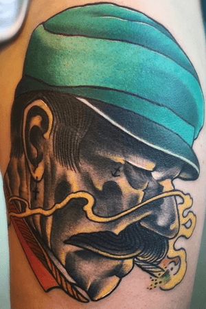 Neotraditional face on the upper thigh. 