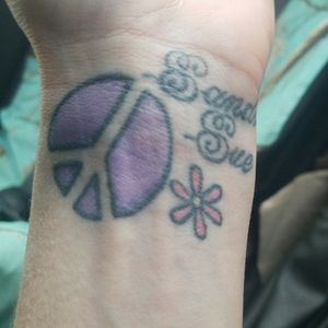Purple peace sign with a pink daisy an my daughters name Sandra Sue. About 8 years old an still looks amazing