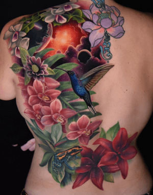 Rainforest backpiece complete with floral work, space, a hummingbird and a dart frog. Color realistic