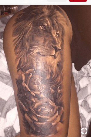 Black and white lion hip tattoo