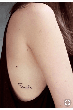 Small smile quote tattoo