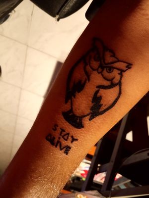 This tattoo means the rise of a person who went down and lost his strengh, the phrase means that i need to Stay Alive and im not alone. The owl means that i will never lose my way and the owl will guide me wisely