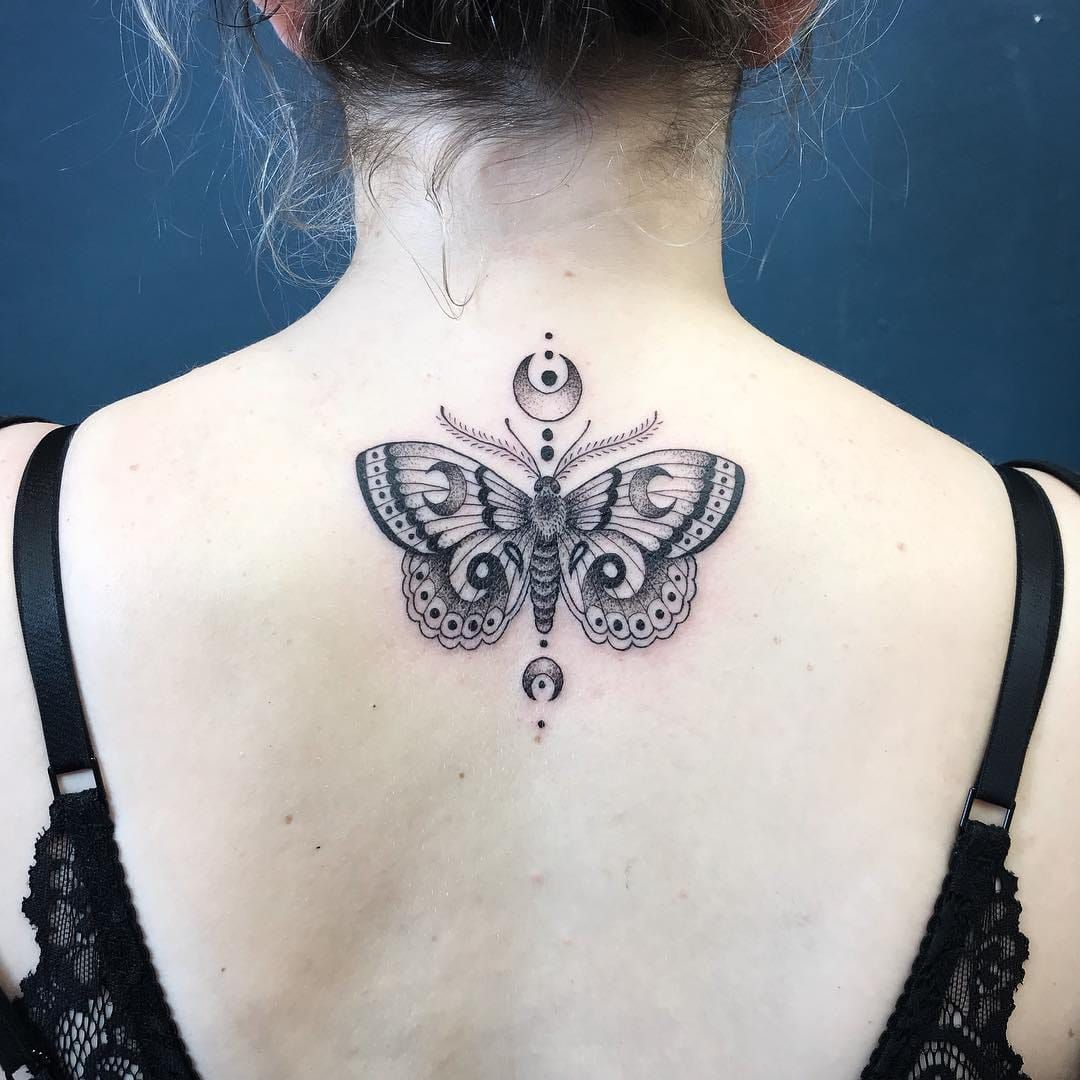 Large moth tattoo done on the upper back