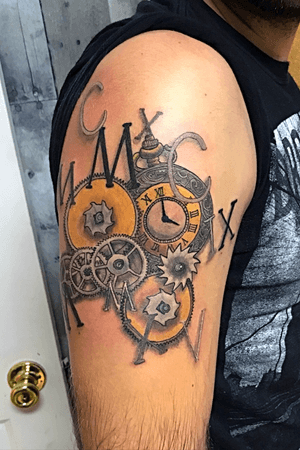 His first move from Albania to Greece, and then his move from Greece to America commemorated in roman numerals. The time on the pocket watch is when his flight landed at JFK airport. 