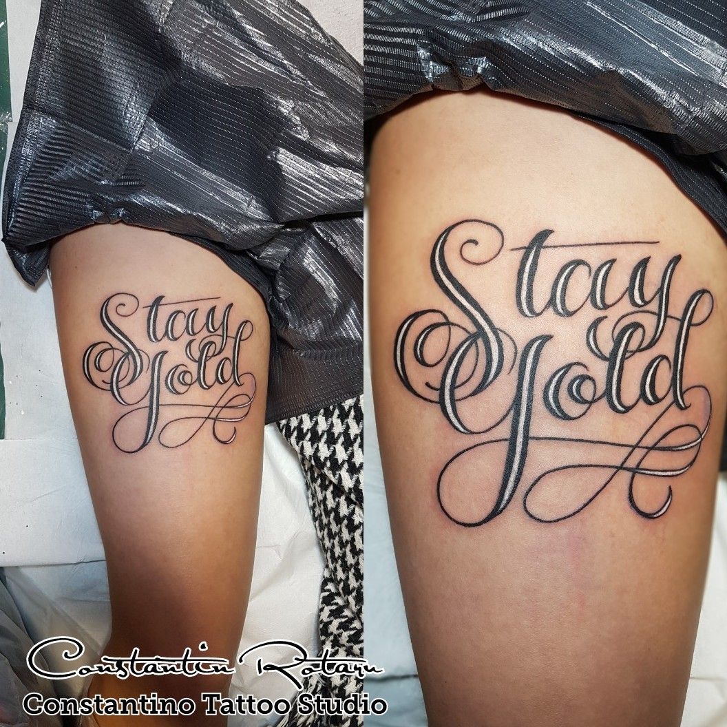 Handwritten tattoo that says stay gold located on the