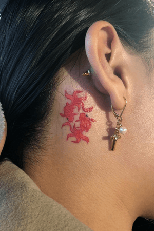 Piscis tattoo: two gold fish behind my ear 