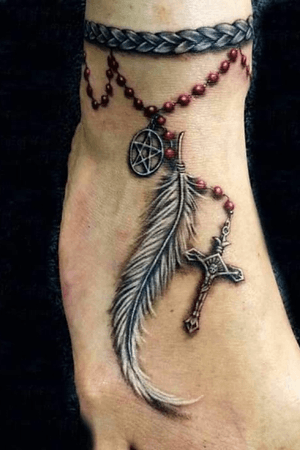 Ankle tattoo idea. Feather with cross done using white ink