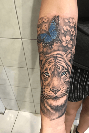 Realistic tattoo. Tiger, flowers and butterflies