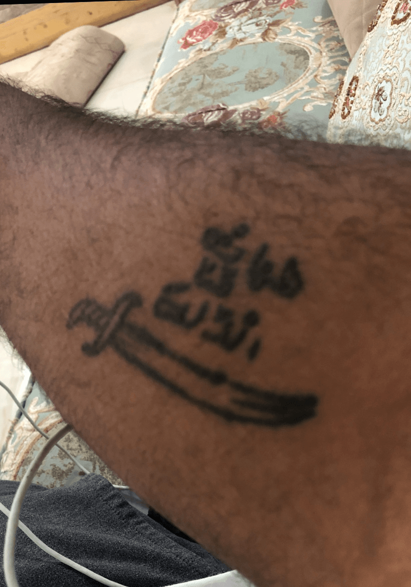 Inner arm tattoo saying Freedom in arabic حرية