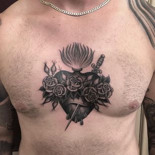 Tattoo by Tim Hendricks #TimHendricks #sacredhearttattoos #sacredhearttattoo #sacredheart #heart #fire #love #religious #Chicano #blackandgrey #rose #flower #sword #blood #dagger #chesttattoo