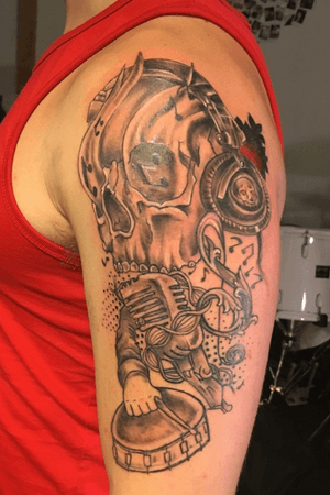 Music inspired skull arm tattoo. Drummer 
