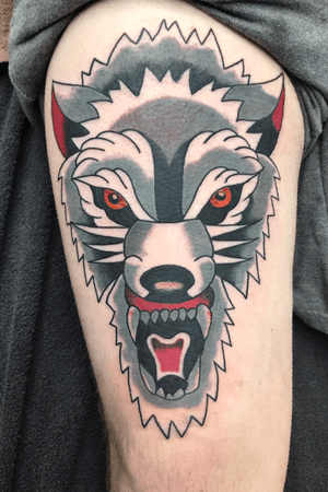 Traditional wolf thigh tattoo