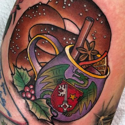 Tattoo by Guen Douglas #GuenDouglas #ChristmasTattoos #Christmastattoo #christmas #xmas #holiday #winter #mulledwine #holly #dragon #coatofarms #cinnamon #alcohol #pretzel #food #wine