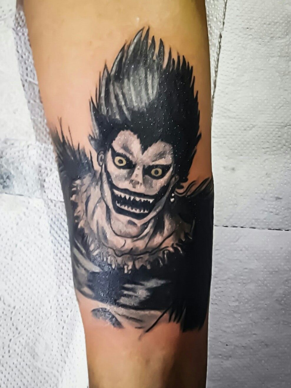 Just wanted to show yall my Ryuk tattoo Yes this is actually me Still  learning Reddit pls be kind I hope you guys like it   Artwork credit  to my tattooist