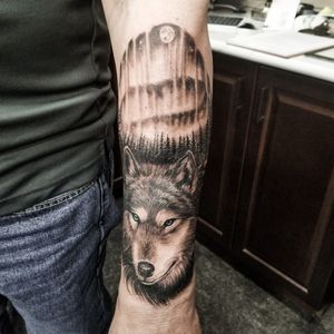 Northern lights wolf and forest tattoo