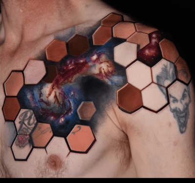 Nebula/ space tattoo on the chest surrounded by geometric framework. This piece also incorporates 2 old tattoos along the outer edge. 