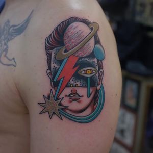 Tattoo by Andrei Vintikov #AndreiVintikov #tattoosoffamouspeople #famouspeopletattoos #famous #portrait #people #davidbowie #color #surreal #lightningbolt #saturn #glaaxy #traditional