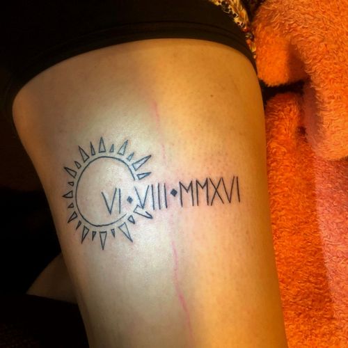 Client wanted a simple tattoo with minimal ink that had a Sun and her sons birthday in roman numerals