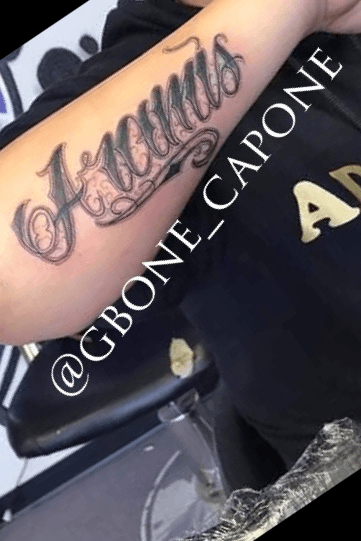 gonzalez in cursive tattoos