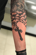Freehand Black and gray Rosary wrapping around the forearm. Reworked the clouds a bit above to blend into current work. 