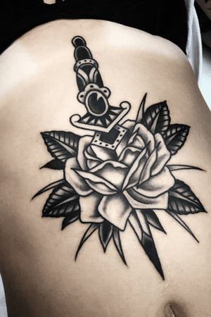 Tattoo by Steve Zimovan #blackwork #blackandgrey #blackworktattoo #rose #dagger #sternumtattoo #brightandbold #traditional #traditionaltattoo #ashevillenc #ashevilletattoos 