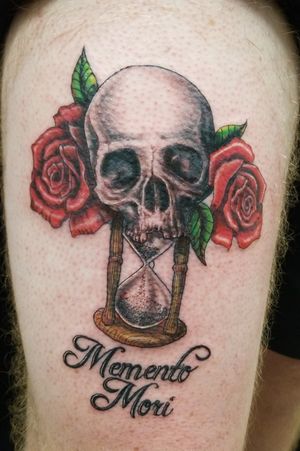 Half skull on hourglass surrounded by roses 