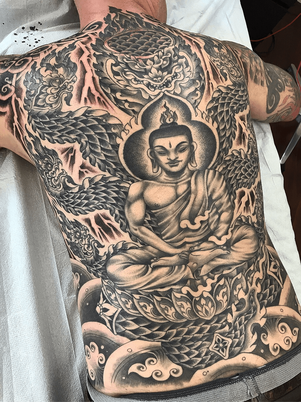 Great meditating buddha tattoo on whole back | Buddha tattoo, Buddha tattoos,  Back tattoo