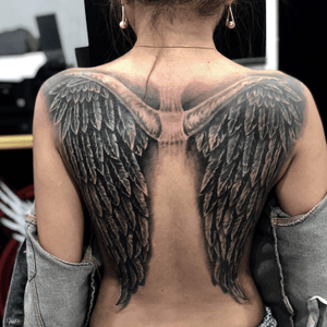 Cover on old small wings tattoo