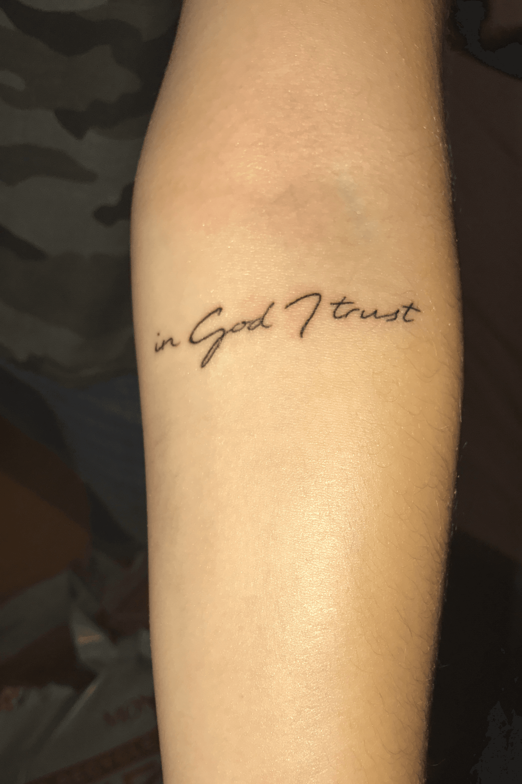 Trust God lettering tattoo on the wrist