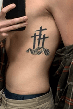The three crosses represent me, my mom and my brother. My mom also has this tattoo just a little different. It was a mother/son tattoo. This was my first tattoo. I love the mountains!