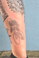 Handpoked skeleton on a bicycle. Placed on clients inner calf amongst other tattoos.