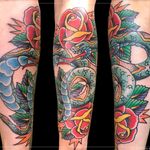 Tattoo by Chad Clark. #snaketattoo #rosetattoo #floridatattooartist #capecoral #tophatclassictattoo #colortattoo #traditional #traditionalsnaketattoo #traditionaltattoo 