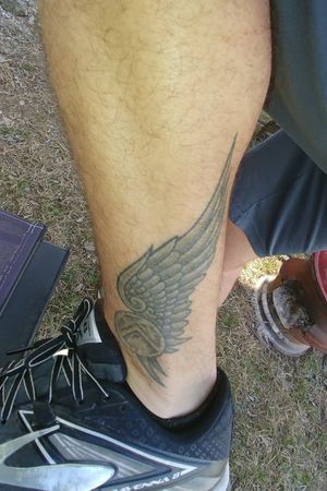 winged track foot tattoo