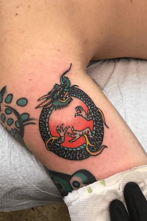 Wild colored traditional dragon desing stuck up inside by the arm pit 