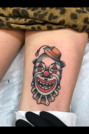 Creepy clown piece on the back of a thigh 