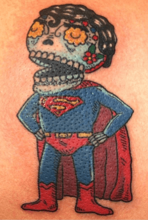 Day if the dead superman tattoo on a leg. 