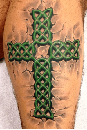 Wild celtic cross pounded into the side of a leg. 