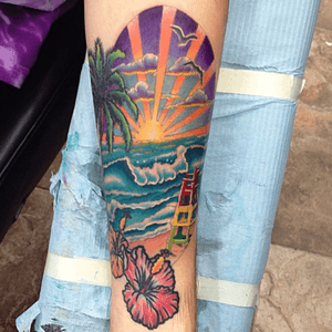 Fun beach scene tattoo done on the inside of a forearm. 