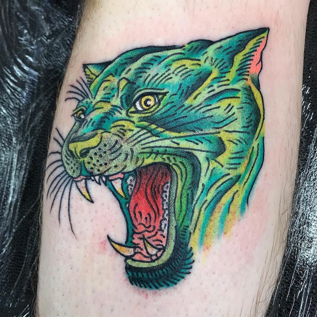 Green Eye Angry Panther Head Tattoo On Left Thigh