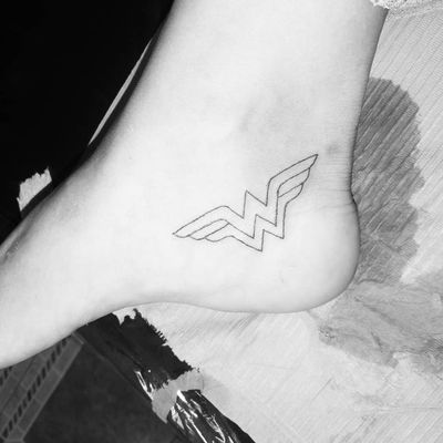 wonder woman logo wrist tattoo