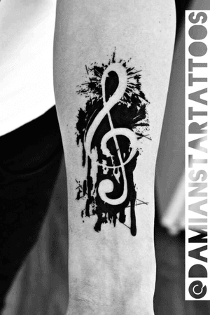 Negative space tattoo of treble cleft
