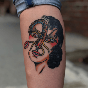Healed tattoo of a bug eyed lady.