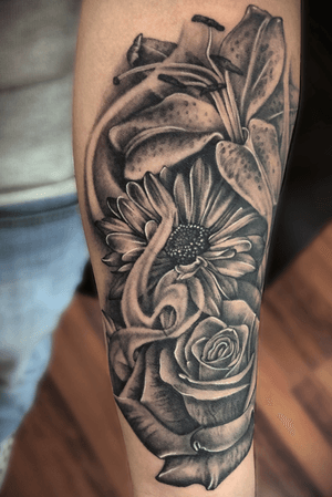 This one was for a great client that was visiting chicago , one of my favorite black and grey pieces to this day . It was completed in a single sitting of around 7 hours .                                                                              #rosesbyaxe #rosetattoo #bnginksociety #flowers #chicagotattoo #blackandgrey #realism #rose #realistic #chicagoink 